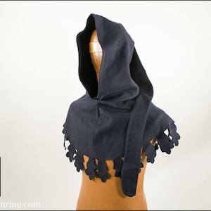 May include: A dark blue hooded cowl with a decorative scalloped edge. The cowl is made of a soft, comfortable fabric and is perfect for keeping warm in the winter.