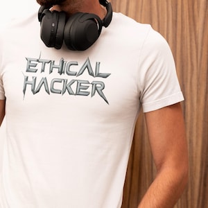 May include: A white t-shirt with the text "ETHICAL HACKER" printed in a stylized, metallic font.