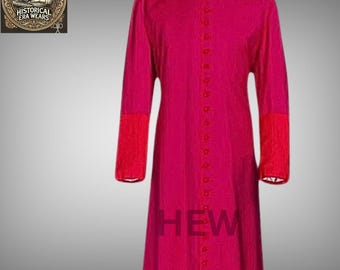 May include: A long, fuchsia-colored cassock with a mandarin collar and a row of buttons down the front. The cassock has red trim on the sleeves and a white collar.
