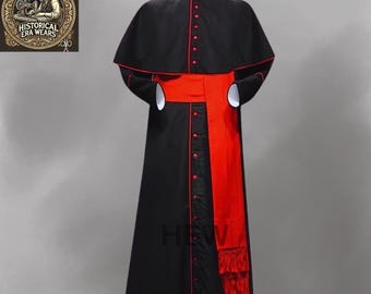 May include: A black cassock with a red sash and red trim. The cassock has a cape and a long, flowing skirt.