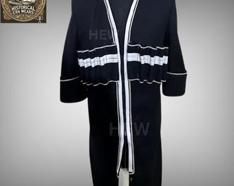 May include: A black long-sleeved coat with white trim and a zip down the front. The coat has a V-neck and is lined with white fabric.