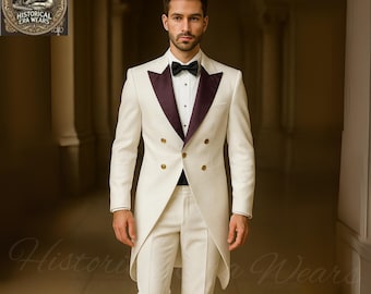 May include: A cream-colored double-breasted suit with a black bow tie and a burgundy lapel. The suit has gold buttons and a long tailcoat design. The image is of a man wearing the suit.
