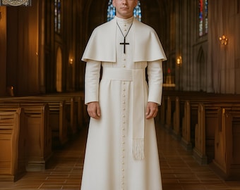 May include: A cream-colored clerical robe with a matching cape and a black cross pendant. The robe features a row of buttons down the front and a fringed sash. The image is set in a church with stained glass windows.
