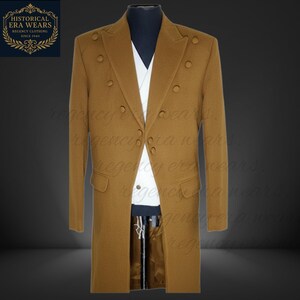 May include: A tan double-breasted overcoat with six buttons and two front pockets. The coat is displayed on a mannequin with a white shirt and black pants underneath. The Historical Era Wears logo is in the upper left corner.