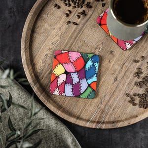 May include: A set of four colourful coasters with a patchwork design. The coasters are made of wood and have a glossy finish. Each coaster features a different pattern of colourful squares and rectangles.