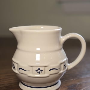 May include: A set of three ceramic mugs with a speckled, matte finish. The mugs are in shades of cream, light gray, and dark gray. Each mug has a simple, minimalist design, perfect for coffee or tea.