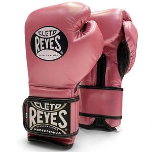 May include: Pink leather boxing gloves with black trim and the logo "Cleto Reyes" in white with the text "Hecho en Mexico" and "Professional" in gold.