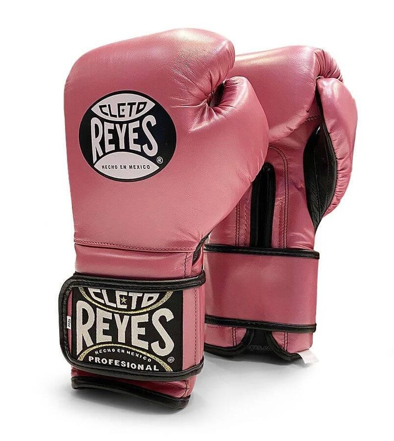 May include: Pink leather boxing gloves with black trim and the logo "Cleto Reyes" in white with the text "Hecho en Mexico" and "Professional" in gold.