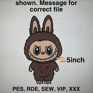 May include: An embroidered design of a cartoon creature with large eyes, a toothy grin, and bunny-like ears. The design is approximately 5 inches in size. Text includes "If file type is not shown. Message for correct file" and file type abbreviations.