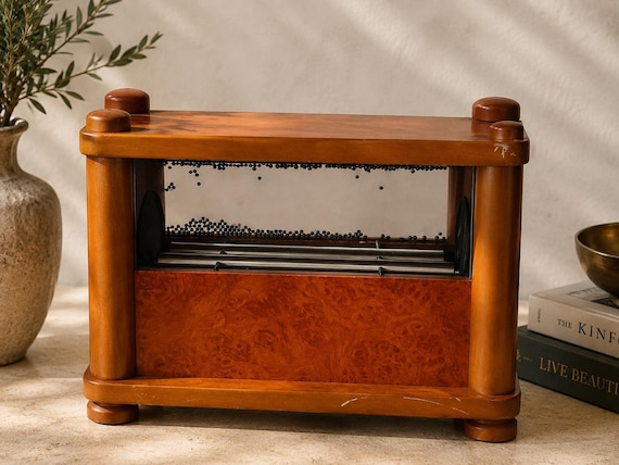 Hand-turned burl wood base meets mesmerizing magnetic gravity-ball kinetics — this is the desk toy that makes visitors stop mid-sentence.