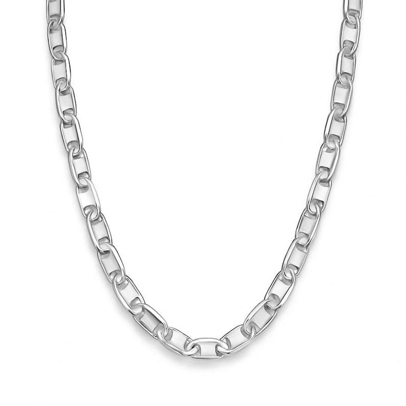 May include: A silver-colored chain necklace with oval links. The necklace is displayed against a white background, highlighting its polished, reflective surface. The chain is a classic jewelry piece.