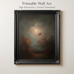 May include: A framed print of a vintage painting depicting a witch flying across a moonlit sky. The artwork is set in a dark, moody landscape with autumn-colored trees. The frame is black with ornate detailing. Text at the top reads "Printable Wall Art".