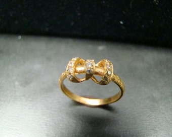 Adorable 14k Gold diamond studded bow ring