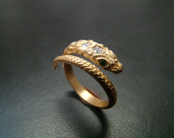 14k Gold amazingly detailed snake ring with diamonds and emerald eyes.