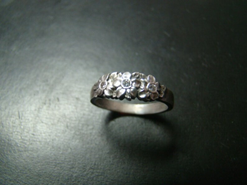 Adorable Sterling Silver flower band with genuine diamonds