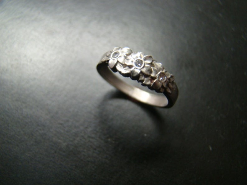 Adorable Sterling Silver flower band with genuine diamonds