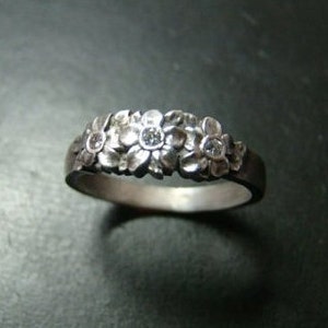 Adorable Sterling Silver flower band with genuine diamonds