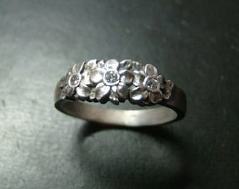 Adorable Sterling Silver flower band with genuine diamonds