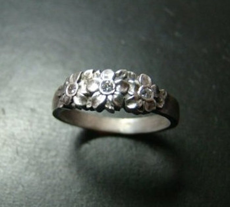 Adorable Sterling Silver flower band with genuine diamonds