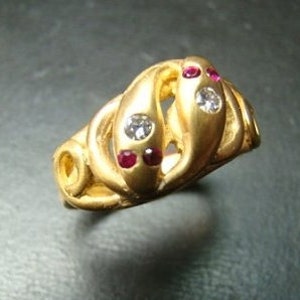Beautiful 14k gold double snake ring with diamonds and rubies