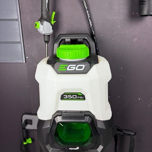 May include: An EGO brand portable pressure washer with a white tank, black base, and bright green accents. The unit features a 350 PSI label, a top handle, a black hose, and a spray wand. The front displays the EGO logo and a green battery compartment.