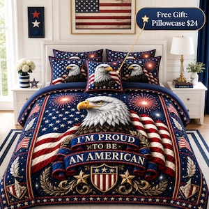 May include: A quilt set featuring a bald eagle, American flag motifs, and fireworks. The central design includes a blue banner with the text 'I'M PROUD TO BE AN AMERICAN' above a shield emblem with stars and stripes, all set against a dark blue background.