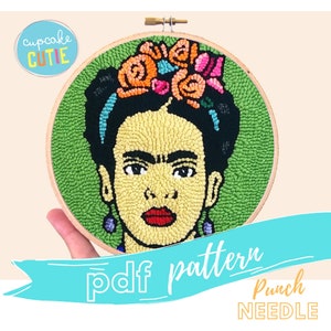 May include: A PDF pattern for a punch needle embroidery project featuring a portrait of Frida Kahlo with a flower crown. The pattern is for a round hoop and includes the text "pdf pattern" and "Punch Needle".