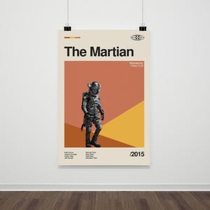 May include: A minimalist movie poster for the film "The Martian" featuring a stylized image of an astronaut in a spacesuit against a background of orange, yellow, and beige. The text "The Martian" is in bold black font and the text "Directed by Ridley Scott" is in smaller black font. The year "2015" is in black font at the bottom right corner of the poster.