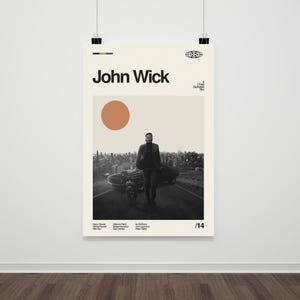 May include: A black and white poster with a minimalist design featuring a man walking with a dog in front of a cityscape. The poster has the text "John Wick" in large, bold letters at the top and the number "14" in the bottom right corner.
