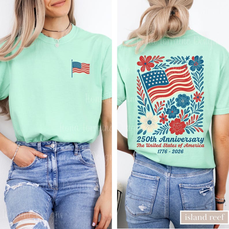 May include: A light green t-shirt with a small American flag on the front and a larger flag design on the back, surrounded by red, white, and blue flowers. The back of the shirt also has the text "250th Anniversary The United States of America 1776-2026."