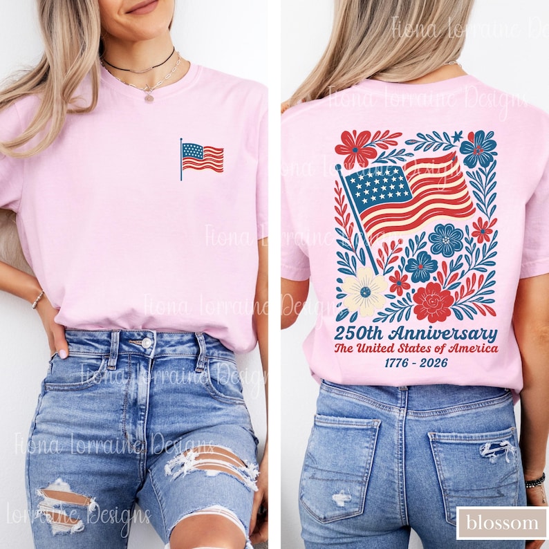 May include: Light pink t-shirt with a small American flag on the front and a larger design on the back. The back design features the American flag, flowers, and text that reads "250th Anniversary The United States of America 1776-2026."