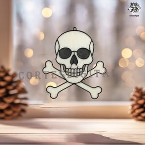 May include: A decorative skull and crossbones ornament with a black outline and a white interior. The skull has black sunglasses and is centered over two crossed bones. The text "Cortes Digital" is partially visible. The ornament is hanging in front of a blurred background.