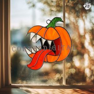 May include: Stained glass pumpkin decoration with an open mouth, sharp white teeth, and a long red tongue. The pumpkin is orange with green stem and black accents, perfect for Halloween decor.