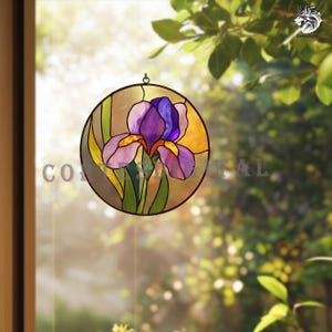 May include: A round stained glass window featuring a purple iris flower with yellow and green accents. The iris is set against a golden background, framed by a dark border. The window is designed to hang, with a small loop at the top.