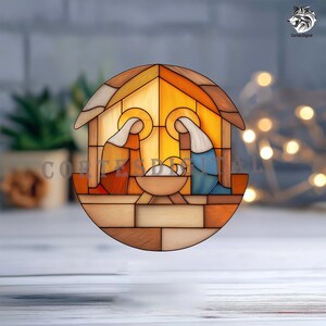 May include: A stained-glass style illustration of the Nativity scene. The image features Mary and Joseph kneeling beside baby Jesus in a manger, all within a wooden structure. The artwork uses warm colors like orange, yellow, and brown.