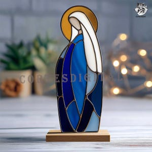 May include: A stained glass figure of a religious icon, featuring a gold halo, white veil, and blue robes. The figure is mounted on a small wooden base. The image has the text "CortesDigital".
