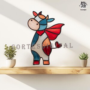 May include: A colorful stained glass cow with a red cape and heart-shaped tail. The cow features blue, red, orange, and white panels. The text "Cortes Digital" is visible at the bottom. The artwork is displayed on a wooden shelf.