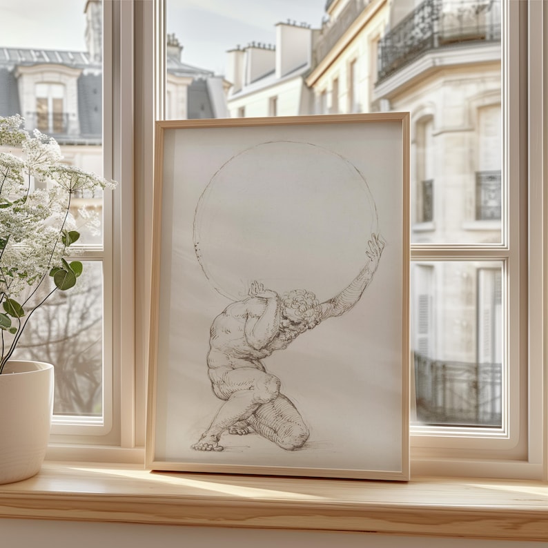 Puede incluir: Una impresi&oacute;n enmarcada de un dibujo cl&aacute;sico que representa a Atlas, una figura mitol&oacute;gica, sosteniendo una gran esfera. La obra de arte est&aacute; en un marco de madera clara, frente a una ventana con vistas a edificios. El dibujo es en tonos grises y beige.