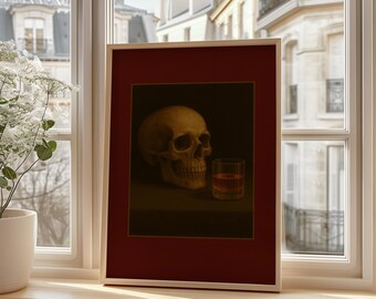 May include: A framed still life painting featuring a human skull and a glass of amber liquid. The artwork is set against a dark background, framed in a red mat and a light wood frame. The painting is displayed on a wooden windowsill.