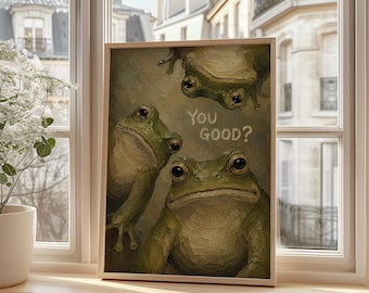 May include: A rectangular framed print featuring an oil painting of three green frogs with textured brushstrokes. The frogs are positioned at different angles against a muted olive background. The text "You good?" is printed in white in the center.