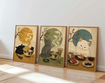 May include: Three framed rectangular wall art prints featuring cats. The left print shows a black cat with a bowl of ramen. The center print depicts a gray cat with a bowl of matcha. The right print displays a white cat eating sushi.