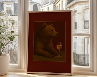May include: Framed art print featuring a brown bear with a glass of wine. The bear is depicted in a relaxed pose against a deep red background. The artwork is displayed in a light-colored wooden frame, set on a windowsill.