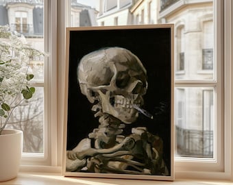 May include: A framed painting of a human skull smoking a cigarette against a black background. The skull is painted in shades of gray and white, with visible teeth and bone structure. The artwork is displayed in a wooden frame.