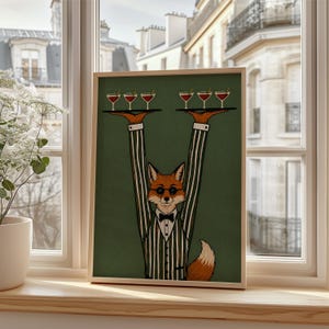 May include: A framed art print featuring a fox in a tuxedo and glasses, holding trays of cocktails. The fox is depicted with orange fur and a white and black striped suit. The background is a solid green color.