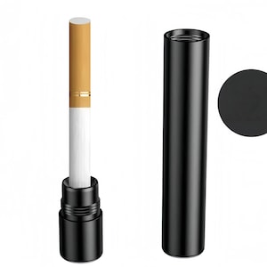 May include: A cigarette with a tan filter and white body is partially inserted into a black cylindrical metal case. Next to it stands a matching black cylindrical metal cap, and a black circular icon is positioned to the right side.