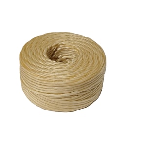 May include: A cylindrical spool of light beige twine wound in a tight, continuous coil. The cord features a smooth, slightly glossy texture and a consistent thickness throughout the entire length of the wound bundle, forming a circular shape.