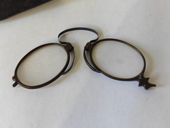 Pair of antique folding pince nez eyeglasses in leather case
