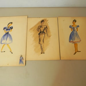 May include: Three watercolor illustrations of women wearing dresses. The illustrations are on separate pieces of paper. The woman on the left is wearing a blue dress with white trim. The woman in the middle is wearing a black dress with a white collar. The woman on the right is wearing a blue dress with a white collar and a red belt.