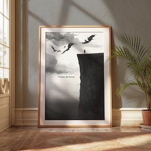 Op de afbeelding: Een ingelijste zwart-wit kunstprint met een illustratie van draken die over een klif vliegen. Een eenzaam figuur staat op de rand, met de tekst "It's been, My Honour" eronder. De print is gepresenteerd in een goudkleurige lijst.