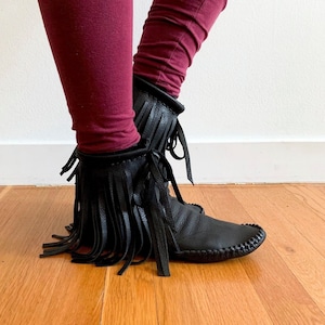 handmade moccasins | indigenous maker | fringe moccassins | hi-top moccasins | moccasin boots | fringe boot | black leather | barefoot shoes